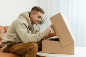 feature image of man unboxing a delivery for Automated Product Fulfillment blog